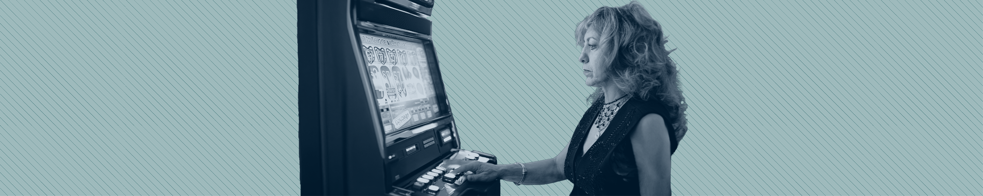 A woman stands in front of a video slot machine, seemingly hypnotized.