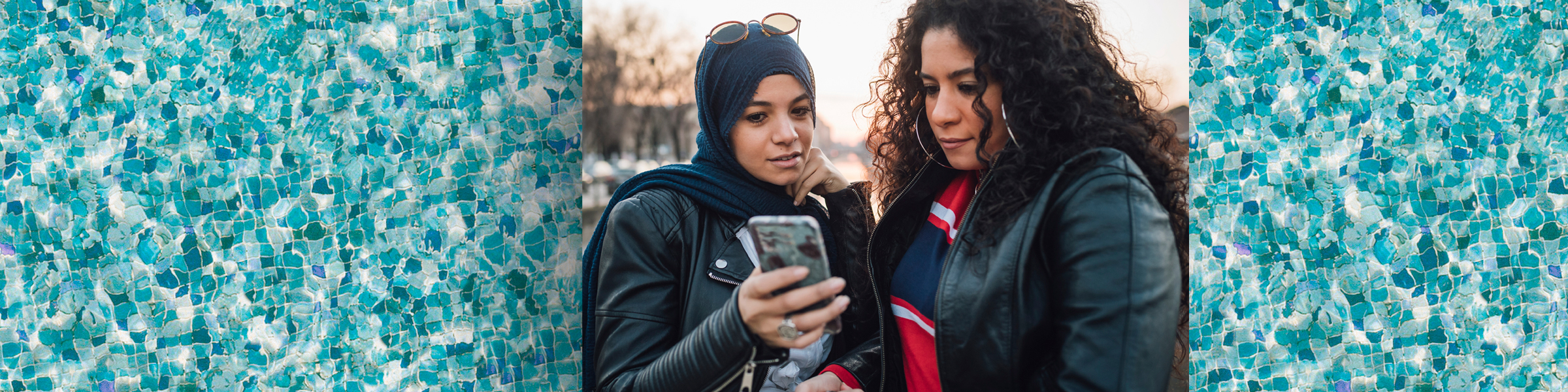 two women look at a mobile phone